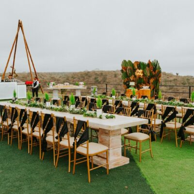 Long dining tables set for an outdoor event